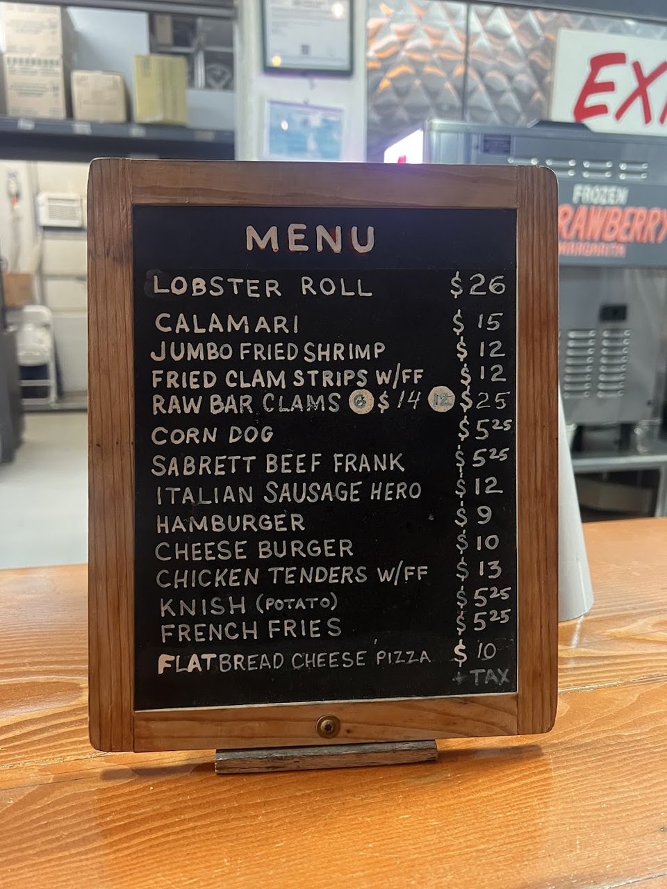 Menu board with fried seafood and draft beer.